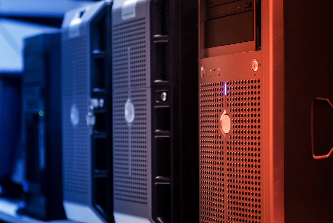 Services Close-up of tower servers in a data center with blue and red lighting.